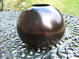 Ebonised and waxed wooden vase